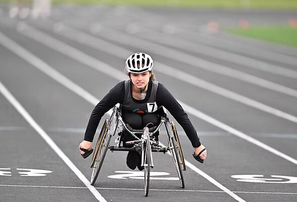 A young women competes in a wheelchair track event at Dairyland Games