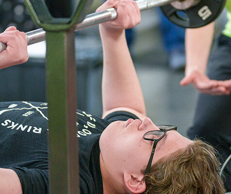 A close-up of a participant in Dairyland Sports Fitness Foundations program doing a chest press