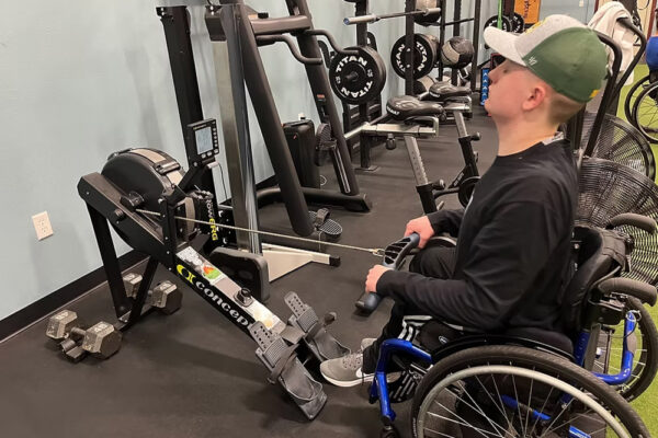 Fitness Foundations program participant uses an adapted row machine