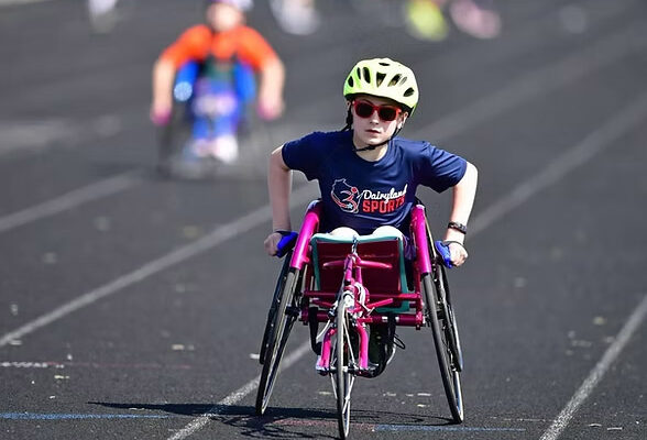 A young wheelchair racer on an outdoor track