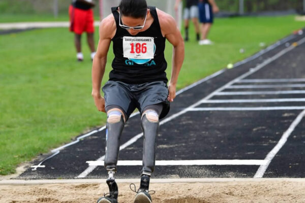 An adaptive athlete lands a long jump at the Dairyland Games