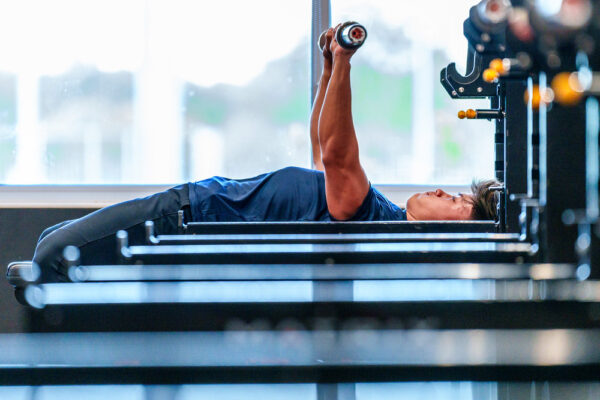 A participant performs a bench press as part of Dairyland Sports' Fitness Foundations program