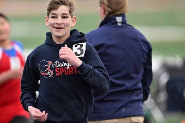 A young competitor smiles as he participates in a Dairyland Games event